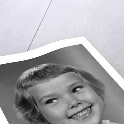 1960s smiling girl looking off to the side by Anonymous