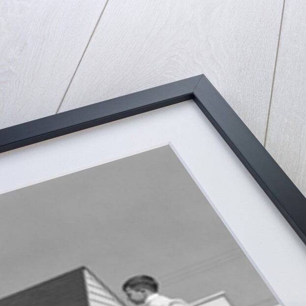 1950s boy walking balancing on fence other children standing sitting next to fence by Anonymous