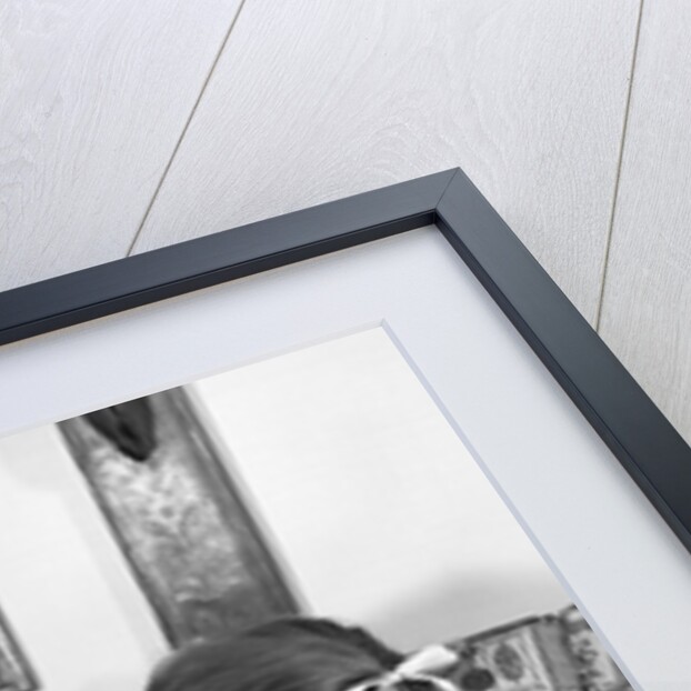 1960s mother sitting on couch with son and daughter by Anonymous