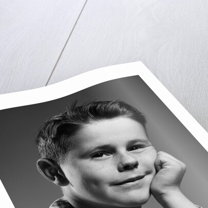 1950s child portrait boy with freckles posed resting head cheek on hand by Anonymous