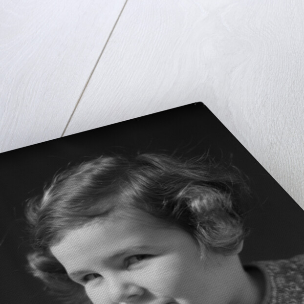 1930s little girl with finger to lips making quiet gesture looking at camera by Anonymous