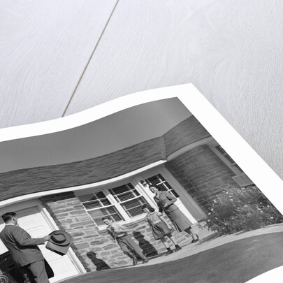 1950s family greeting father in driveway by Anonymous