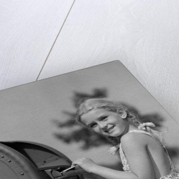 1930s 1940s child blond little girl with pigtails putting letter into mail box, looking at camera by Anonymous