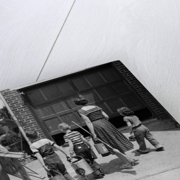 1950s family mother father 3 children from behind carrying gardening home improvement tools equipment by Anonymous