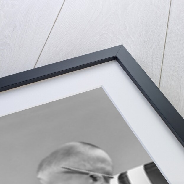 1950s child typing sitting at typewriter by Anonymous