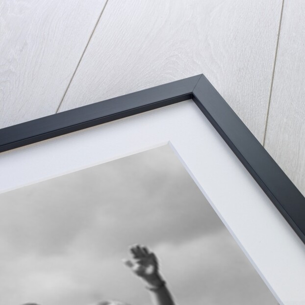 1930s girl sitting on fence with woman next to her in field waving by Anonymous