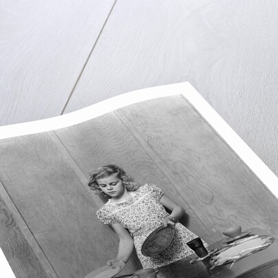 1940s blond pre-teen young woman setting table by Anonymous