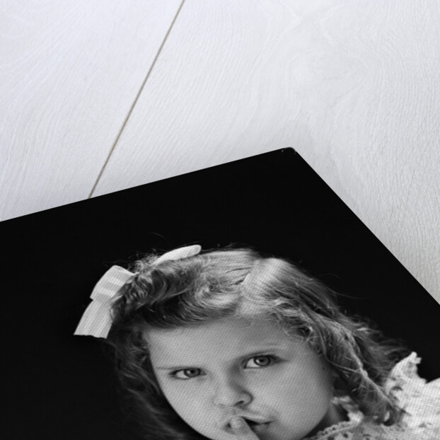 1950s child serious little girl pressing finger to lips hush be quiet secret by Anonymous