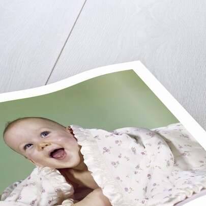 1960s smiling happy baby peeking out from under a blanket by Anonymous