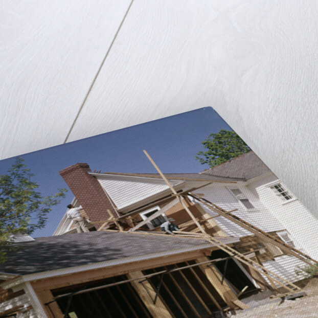 1960s 1970s workers building two car garage addition onto suburban home by Anonymous