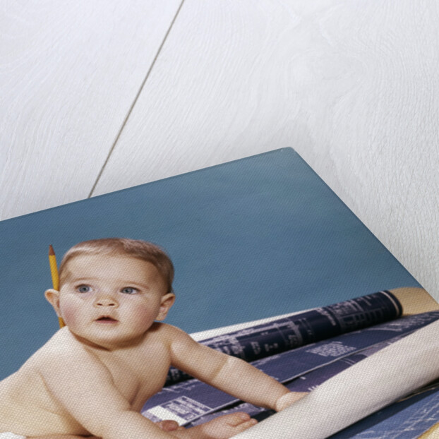 1960s baby architect sitting among blueprints by Anonymous