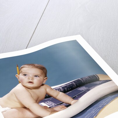 1960s baby architect sitting among blueprints by Anonymous