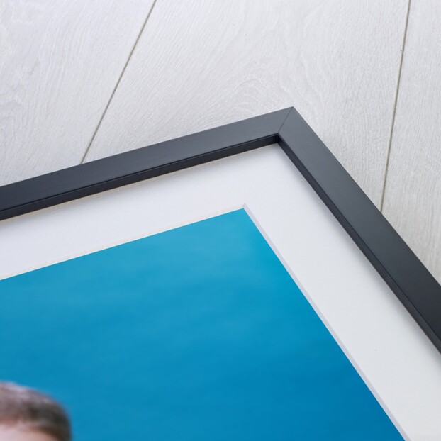 1960s baby eyes closed funny facial expression crawling on rolling out blueprints by Anonymous