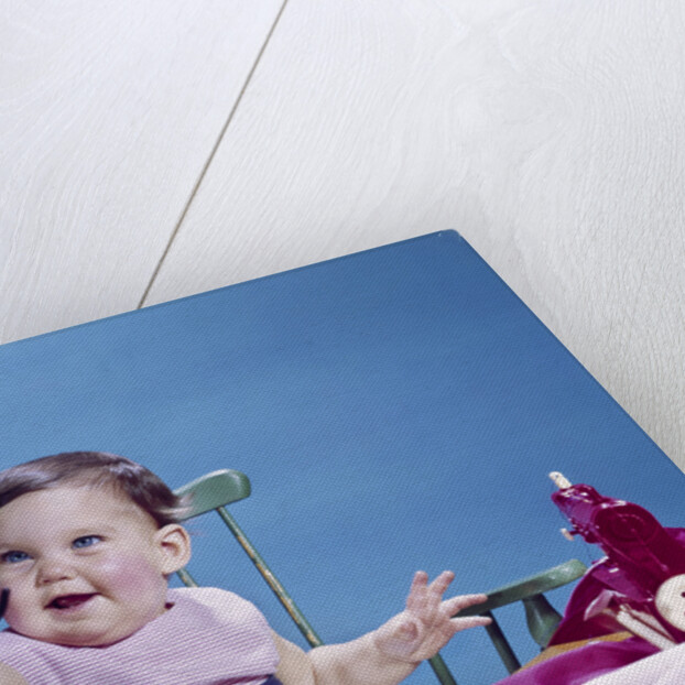 1960s smiling baby holding eyeglasses by Anonymous
