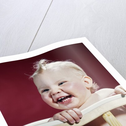 1960s laughing blond baby in crib or playpen by Anonymous