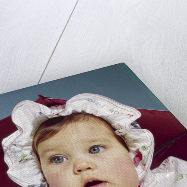 1960s baby wearing raincoat and hat by Anonymous