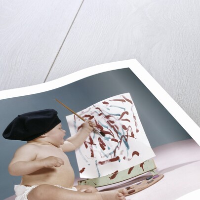 1960s baby artist wearing black beret sitting in front of easel painting by Anonymous