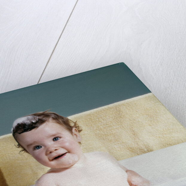 1960s smiling baby in bath looking at camera by Anonymous