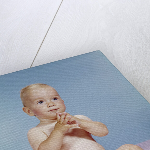 1960s baby wearing cloth diaper sitting with hands together thoughtful pose expression by Anonymous