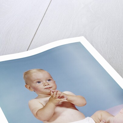 1960s baby wearing cloth diaper sitting with hands together thoughtful pose expression by Anonymous