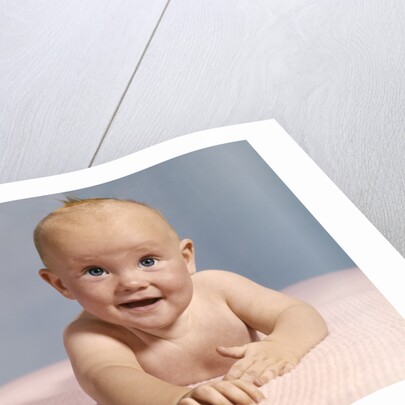 1970s smiling happy baby crawling straight ahead on pink blanket looking at camera by Anonymous