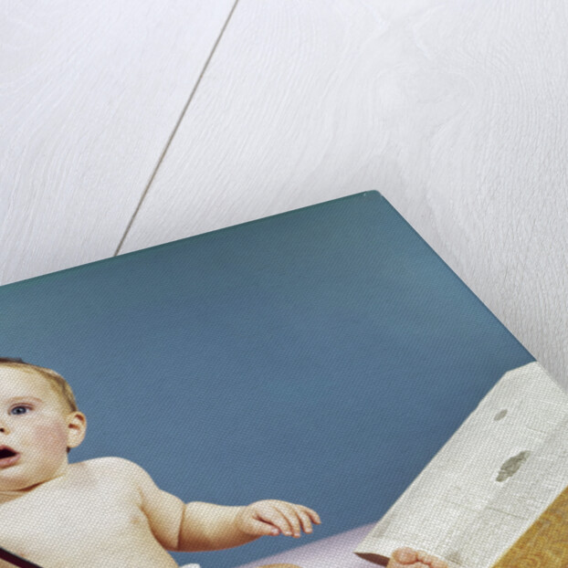 1960s baby holding eyeglasses with open dictionary and magnifying glass research by Anonymous