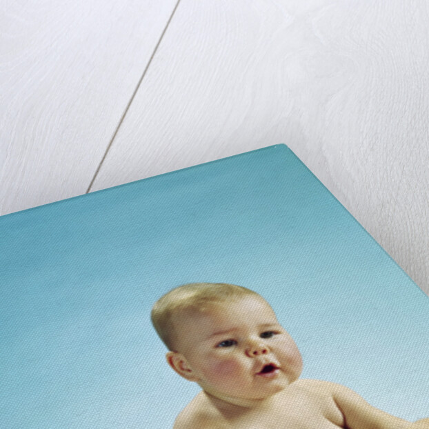 1960s baby sitting holding on to his feet by Anonymous