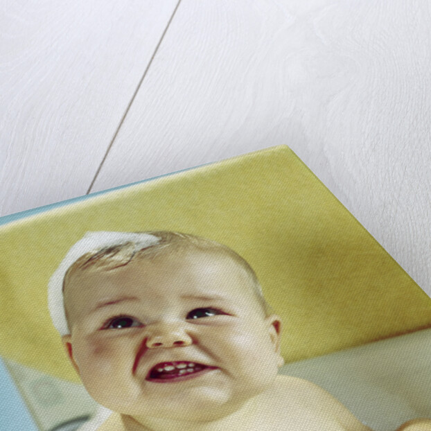 1960s smiling baby in bath looking up by Anonymous