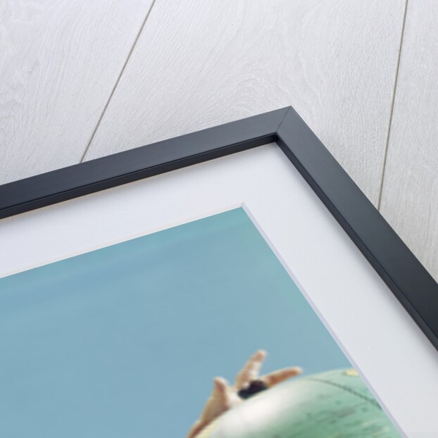 1960s baby wearing eyeglasses hugging the world globe earth by Anonymous