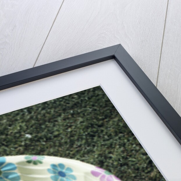 1970s baby sitting in plastic backyard kiddy pool viewed from above by Anonymous