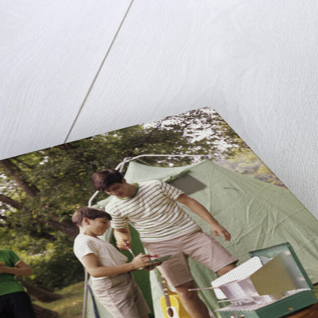1960s three boys at campsite cooking camp stove eating food tent teens by Anonymous