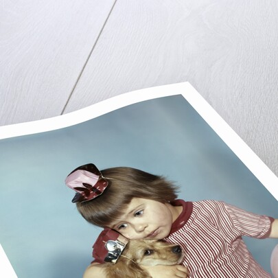 1950s 1960s little girl wearing party hat frowning hugging a cocker spaniel puppy by Anonymous