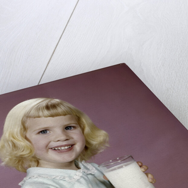 1960s girl glass milk dairy smile looking at camera by Anonymous