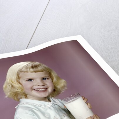1960s girl glass milk dairy smile looking at camera by Anonymous