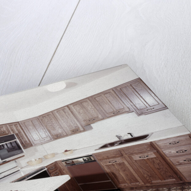 1970s kitchen with dark wooden cabinets and a microwave oven over the stove by Anonymous