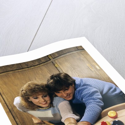 1980s teen couple playing pool by Anonymous