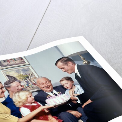 1960s three generation family with birthday cake by Anonymous