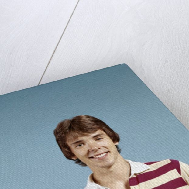 1970s portrait of smiling teenage boy wearing striped rugby shirt looking at camera by Anonymous
