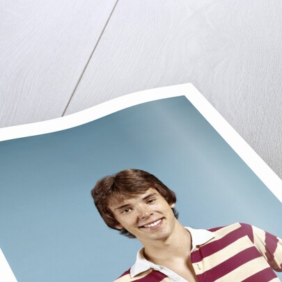 1970s portrait of smiling teenage boy wearing striped rugby shirt looking at camera by Anonymous