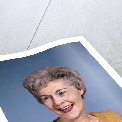 1960s portrait smiling elderly woman wearing orange top laughing looking to side by Anonymous