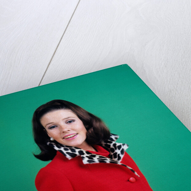 1960s smiling young woman brunette red coat leopard skin fur collar by Anonymous