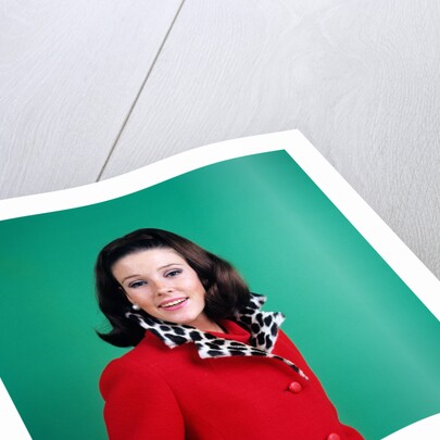 1960s smiling young woman brunette red coat leopard skin fur collar by Anonymous