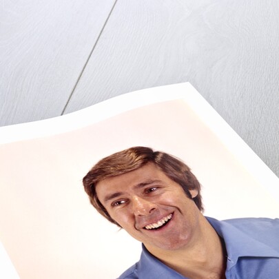 1970s man portrait head shoulders blue shirt laughing toothy smile by Anonymous