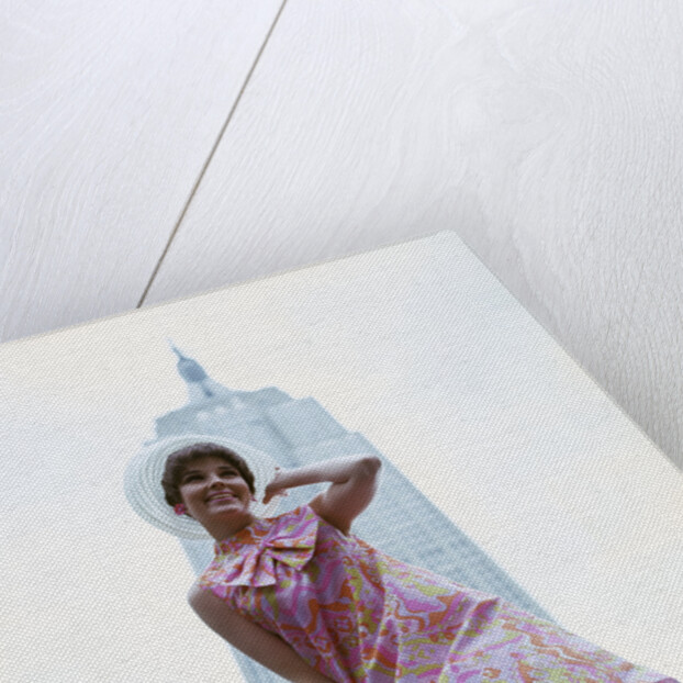 1960s young woman print miniskirt dress summer hat in front empire state building new york city by Anonymous