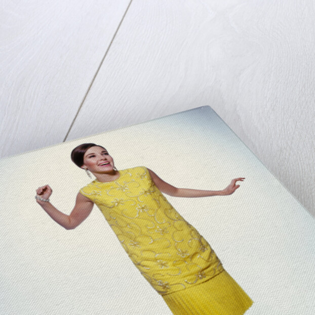 1960s smiling brunette woman modeling yellow sequined cocktail dress clothes by Anonymous