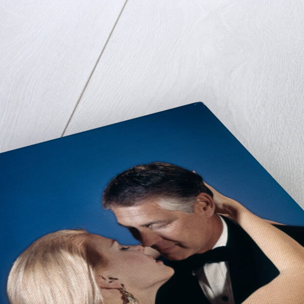 Romantic couple embracing about to kiss husband wife evening dress studio 1970s 1960s by Anonymous