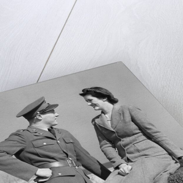 1940s happy couple man wearing army uniform woman sitting on stone wall by Anonymous