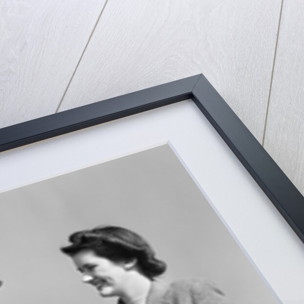 1940s happy couple man wearing army uniform woman sitting on stone wall by Anonymous