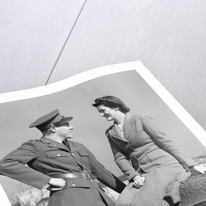 1940s happy couple man wearing army uniform woman sitting on stone wall by Anonymous