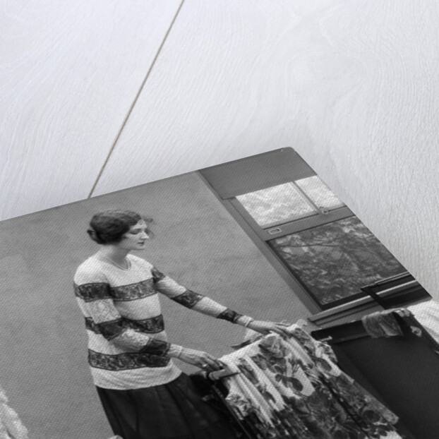 1920s woman packing clothes for travel by Anonymous